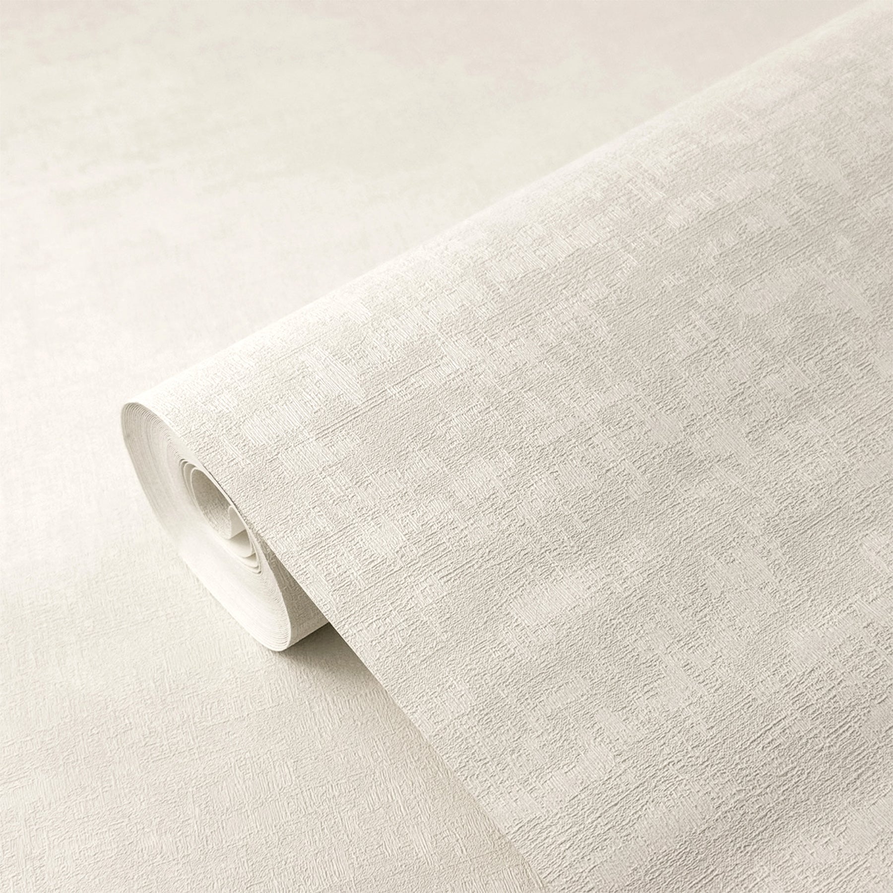 A roll of textured wallpaper in a light warm gray or off-white tone, partially unrolled to show its surface pattern and thickness.